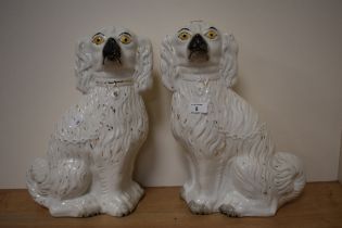 Two 20th century Staffordshire flat back dogs, having gilt heightening.