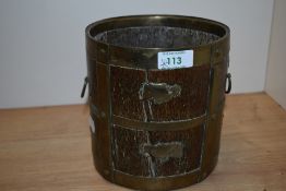 An 19th century Indian rice measure, having brass bands to wood and brass looped handles with