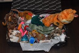 A collection of TY Beanie Babies soft toys and a box of vintage games, including Lexicon
