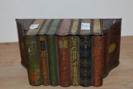 A Huntley and Palmer biscuit tin in the form of a shelf of books.