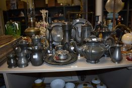 An assorted collection of antique pewter ware, including a Victorian teapot, measures, and an