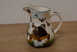 A modern Wymss pottery jug, having bee and hive design.