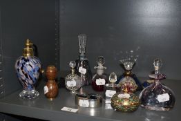 An assorted collection of art glass scent bottles, an atomizer of similar design, an A.E Williams