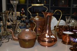 An early 20th century brass and copper teapot, brass trivet and two other brass and copper items