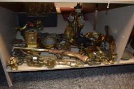 An assorted collection of vintage brassware, door stops, an ornamental flintlock pistol, horse