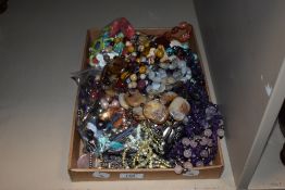 A box of assorted costume jewellery, polished stone necklaces, and other decorative jewellery