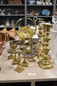 A group of three vintage brass match strikes, two pairs of brass candlesticks and two pairs of