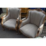 A pair of French gilt wood easy chairs