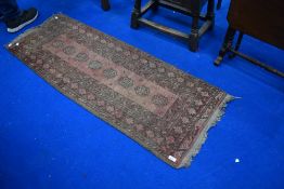 A traditional Persian style small runner or prayer rug