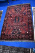 A traditional Persian rug, deep red shades, approx. 150 x 105cm