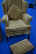 A modern wingback chair and footstool