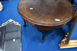 An early 20th Century stained frame circular coffee table
