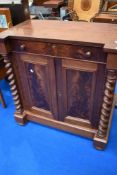 A 19th Century mahogany side cabinet having twist pillars frieze drawer and cupboard section