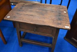 A rustic low work table with frieze drawer on stile frame
