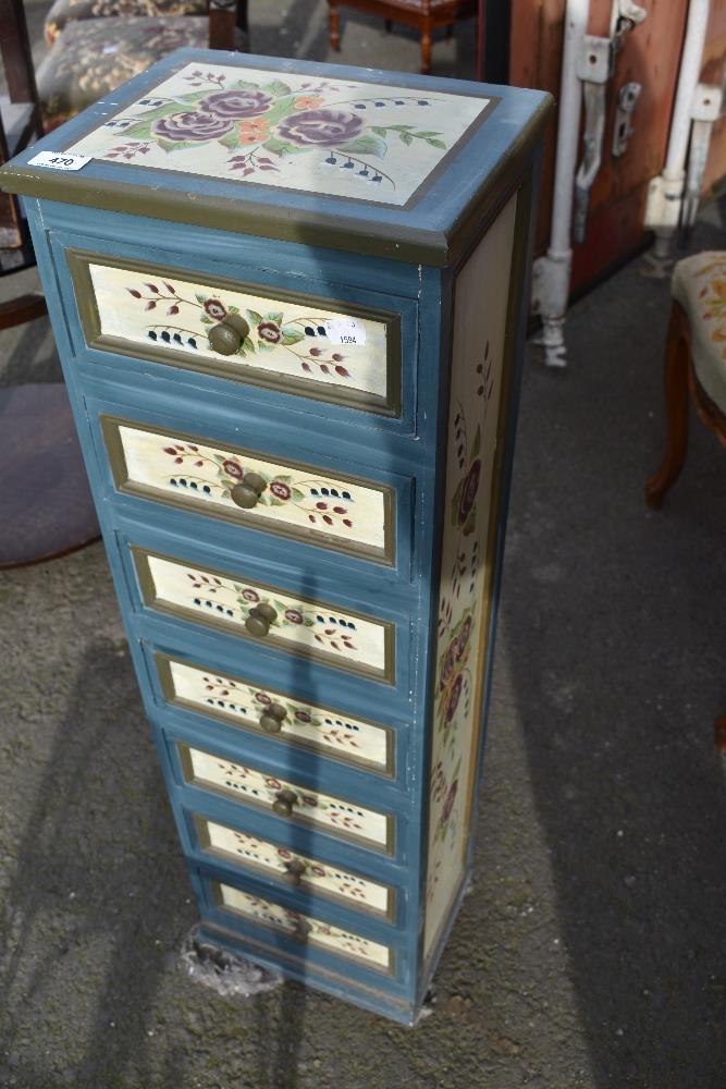 A modern painted narrow chest of storage drawers