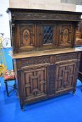 A late 19th or early 20th Century court cupboard having extensive carved decoration, mounted on