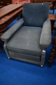 An antique easy chair in the Howard style , of deep proportions