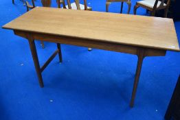 A vintage teak dining table of narrow form with extending flap and slide top mechanism, length