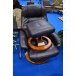 A vintage brown leather swivel chair and similar footstool, similar to stressless