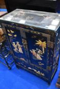 A japanesque side cabinet of small proportions having colourful applique decoration