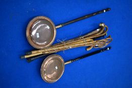Two traditional copper warming pans and a selection of sticks etc