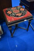A late Victorian ebonised stool in the neo classical style with later upholstered seat
