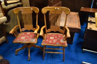 Two vintage stained frame spindle back chairs (armchair and swivel) having upholstered seats