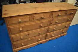 A natural pine wide chest of drawers , four short over two banks of three, width approx. 165cm