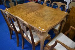 An early 20th Century bleached walnut extending dining table and six (four plus two) vase back