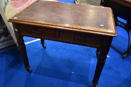 A Victorian mahogany desk having leather inset top and double frieze drawer, on fluted legs
