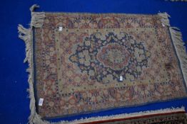 A small fireside or prayer rug (faded colours)