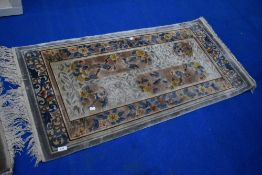 An Oriental silk fireside rug, approx. 122 x 62cm