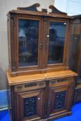 A 19th Century Victorian bookcase on Aesthetic style base with carved border and panels