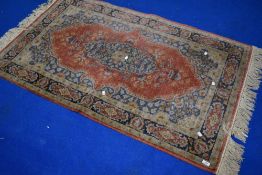 A traditional fireside rug (colours faded)