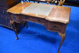 An early 20th Century walnut kneehole desk by Waring and Gillow (stamped to drawer)