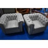 A pair of modern Chesterfield style button back grey leather easy chairs