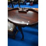 A reproduction hardwood demilune hall table