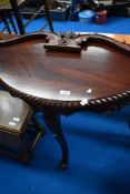 A reproduction hardwood demilune hall table