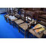 Seven (six plus one) rush seated ladder back chairs