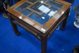 A modern Oriental style glass top square coffee table