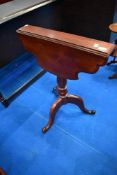 A 19th century occasional pedestal table having Sutherland style top on turned column and triple