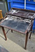 A reproduction fold out desk in need of a good clean
