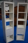 Two white laminate narrow shelving units , Ikea style
