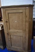 A traditional natural pine double height corner cupboard