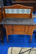 A Victorian stained frame marble top washstand with tile back