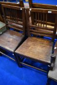 A pair of Georgian mahogany solid seat dining chairs