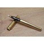 A Sheaffer Classic 1005 fountain pen in in rolled gold fluted design with Sheaffer 14k nib. In