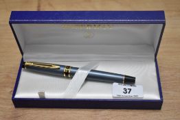 A boxed Waterman Expert cartridge converter fountain pen in grey with gold trim having a Watermans