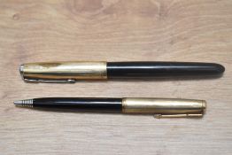 A Parker 51 Aerofill fountain pen and propelling pencil in black with gold filled cap. Wear to