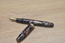 A Conway Stewart 84 lever fill fountain pen in rose marble with single broad band to cap having